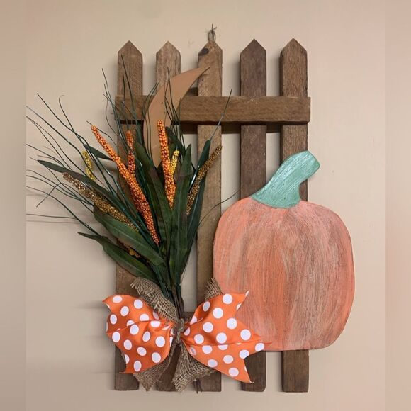 Pumpkin, fall flowers and bow on fence - Picture 1 of 1